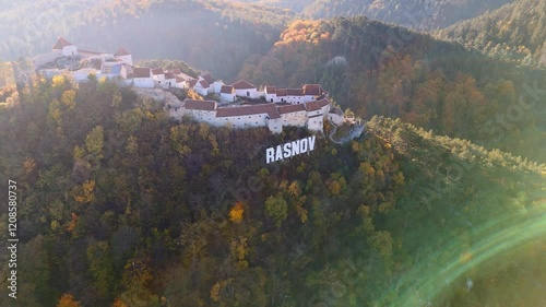 A closer aerial look at the intricate details of Râșnov Fortress, showcasing its walls, inner courtyards, and strategic hilltop vantage point.