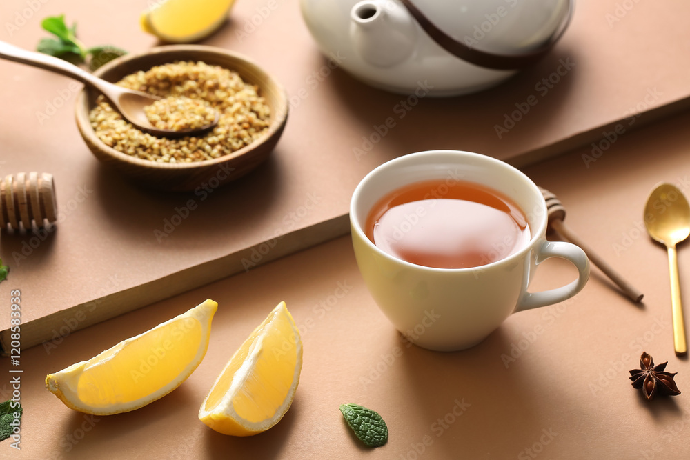 Cup of hot buckwheat tea with lemon slices on brown background Cup of hot buckwheat tea with lemon slices on brown background