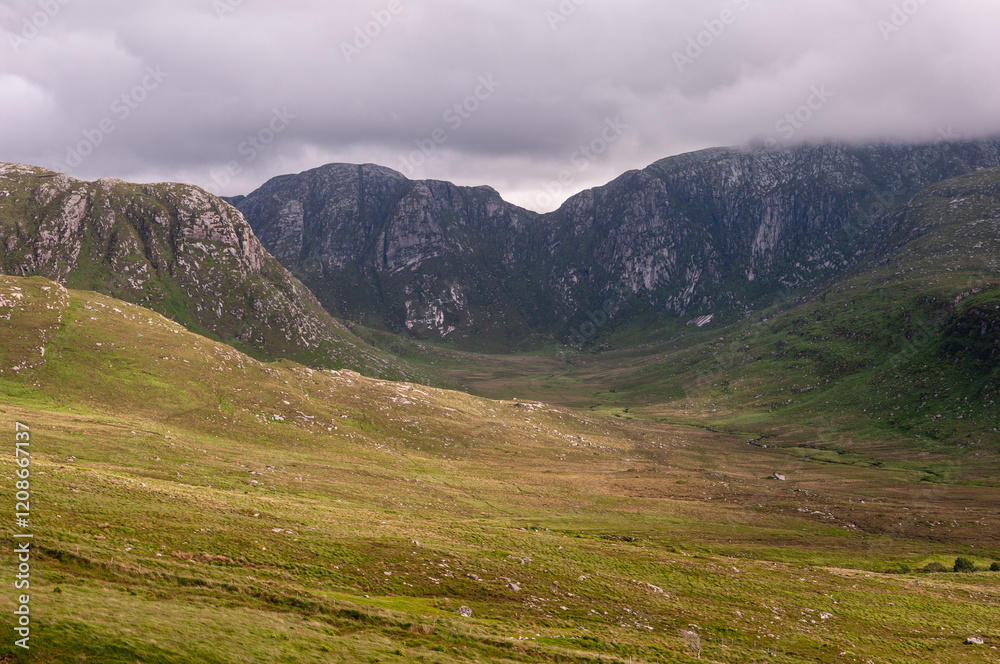 A mountain range with a valley in between A mountain range with a valley in between