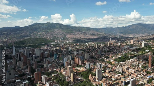 A breathtaking aerial drone view of Medellín, Colombia, showcasing its vibrant cityscape, lush greenery, and stunning mountainous backdrop. This dynamic footage highlights the urban and natural beauty