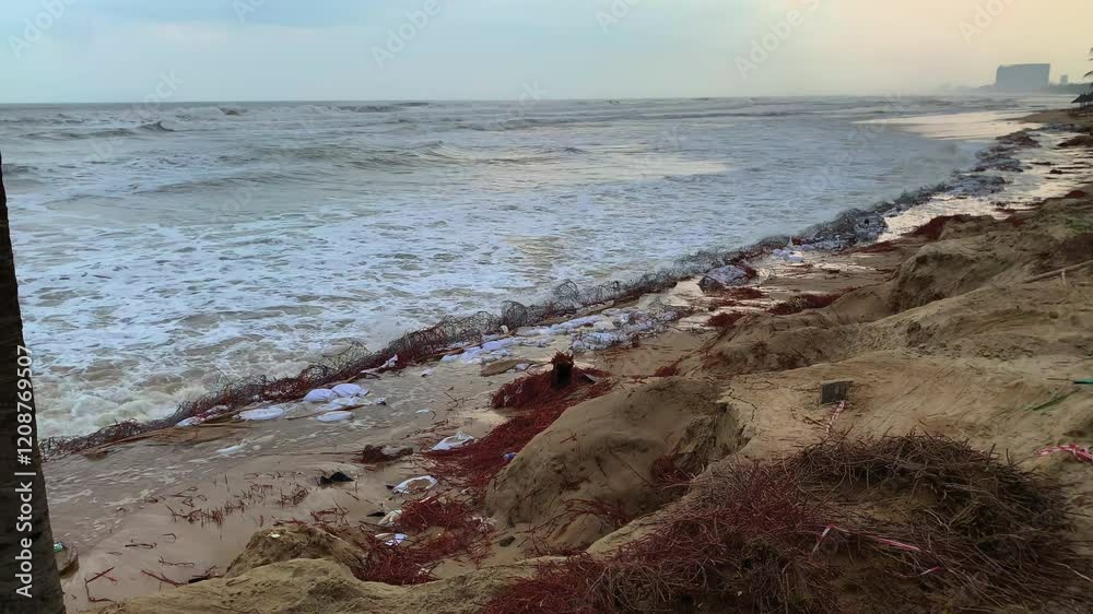 A heavily eroded beach in Da Nang, Vietnam, showing damage from strong ocean waves and coastal degradation. A heavily eroded beach in Da Nang, Vietnam, showing damage from strong ocean waves and coastal degradation.