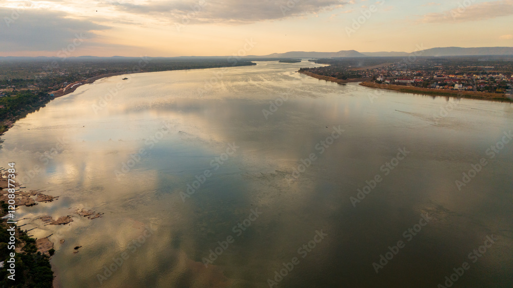 Aerial view at sunset above the Mekong river in Laos revealing Pakse city golden Aerial view at sunset above the Mekong river in Laos revealing Pakse city golden