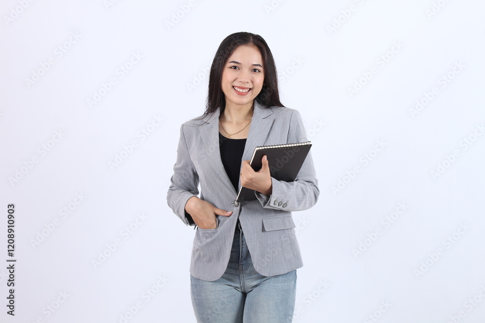 Woman wearing a gray blazer and blue jeans is holding a book. Business asian woman Woman wearing a gray blazer and blue jeans is holding a book. Business asian woman