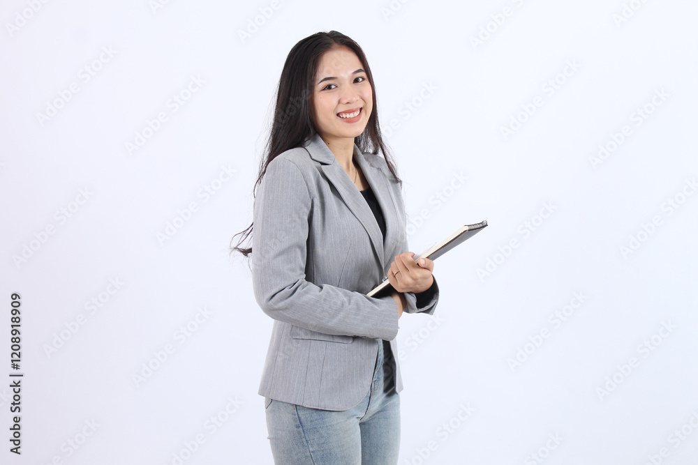 Beautiful woman in a gray blazer and jeans is holding a book. Business asian woman Beautiful woman in a gray blazer and jeans is holding a book. Business asian woman