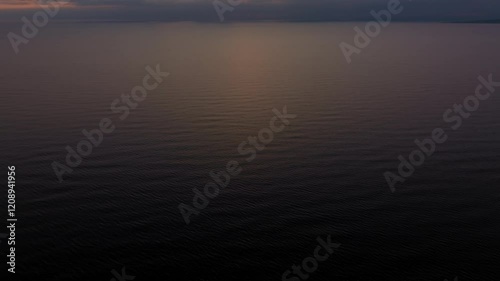 Gentle waves at Kavouri beach near Katakolo, Greece, under a peaceful sunset glow photo