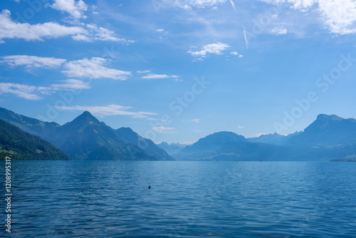 Fototapeta Naklejka Na Ścianę i Meble -  Mountain background. Alps mountain on sunny day. Mountain under clouds in blue sky. Blue nature background. Blue lake with blue sky near mountain.