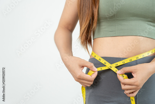 Diet and dieting. Beauty slim female body use tape measure. Woman in exercise clothes achieves weight loss goal for healthy life, crazy about thinness, thin waist, nutritionist.