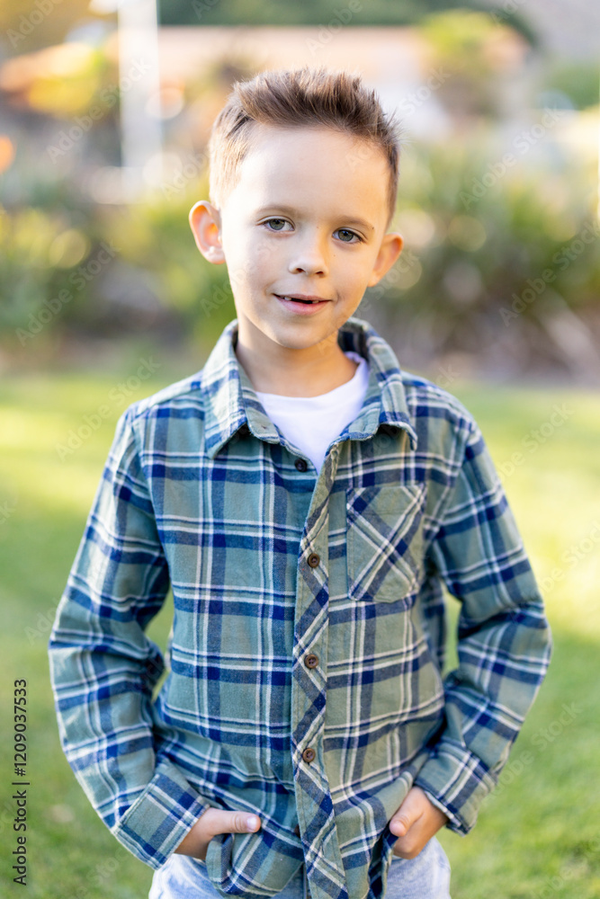 A cheerful young boy confidently poses while wearing a stylish plaid shirt, surrounded by a beautifully vibrant outdoor backdrop, perfectly showcasing his innocence, joy, and carefree spirit A cheerful young boy confidently poses while wearing a stylish plaid shirt, surrounded by a beautifully vibrant outdoor backdrop, perfectly showcasing his innocence, joy, and carefree spirit