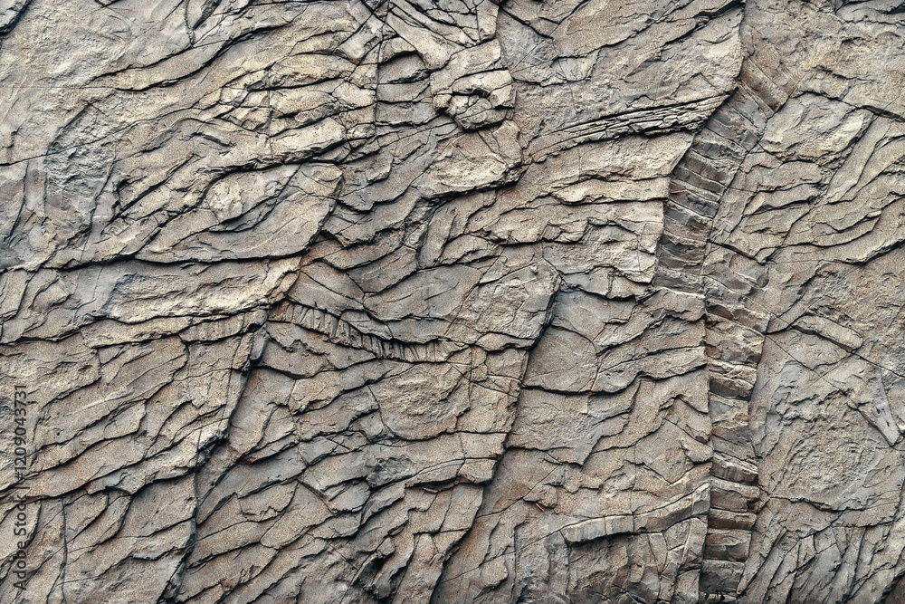 The background of the photo with the texture of a stone wall. The texture of a wall covered with weathering and cracks. Background with natural stone texture. Textured stone wall. The background of the photo with the texture of a stone wall. The texture of a wall covered with weathering and cracks. Background with natural stone texture. Textured stone wall.