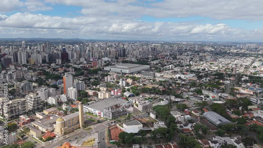 Panoramic aerial view of Curitiba, Paraná, Brazil, with the Ligga Arena stadium prominently in the center of the cityscape. Panoramic aerial view of Curitiba, Paraná, Brazil, with the Ligga Arena stadium prominently in the center of the cityscape.