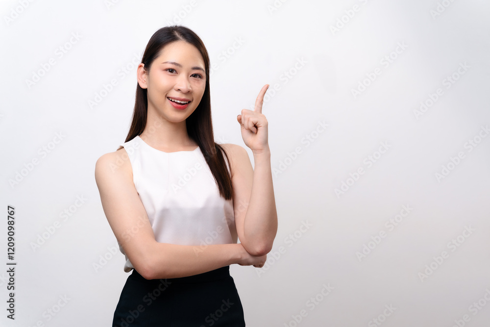 Beautiful businesswoman points her finger up, smiling with happiness and confidence. Beautiful businesswoman points her finger up, smiling with happiness and confidence.