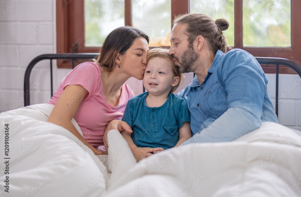 Family enjoying a cozy morning together in bed with warm blankets and natural light Family enjoying a cozy morning together in bed with warm blankets and natural light