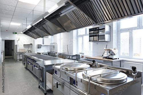 Modern commercial kitchen featuring stainless steel equipment and ample workspace