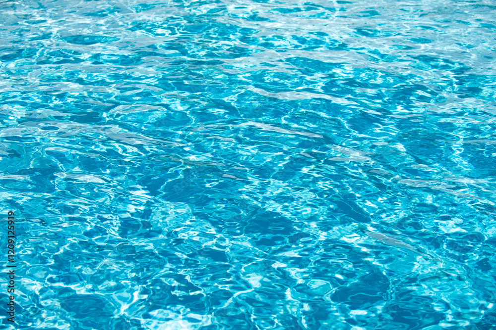 Blue pool water background. Blurred transparent clear calm water surface texture. Water waves in sunlight with copy space. Blue pool water background. Blurred transparent clear calm water surface texture. Water waves in sunlight with copy space.