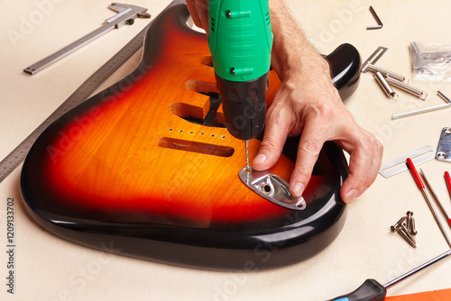 Guitar master screws jack plate in guitar body.