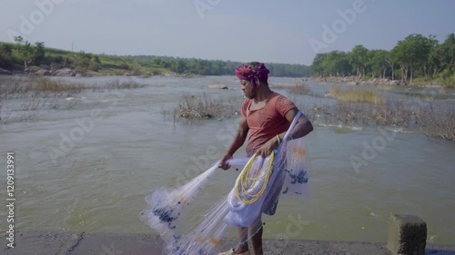 Fishing in the river offers tranquility, patience, and a chance to connect with nature while catching fish in flowing waters.  Unknown people or module. 01st Jan 2025