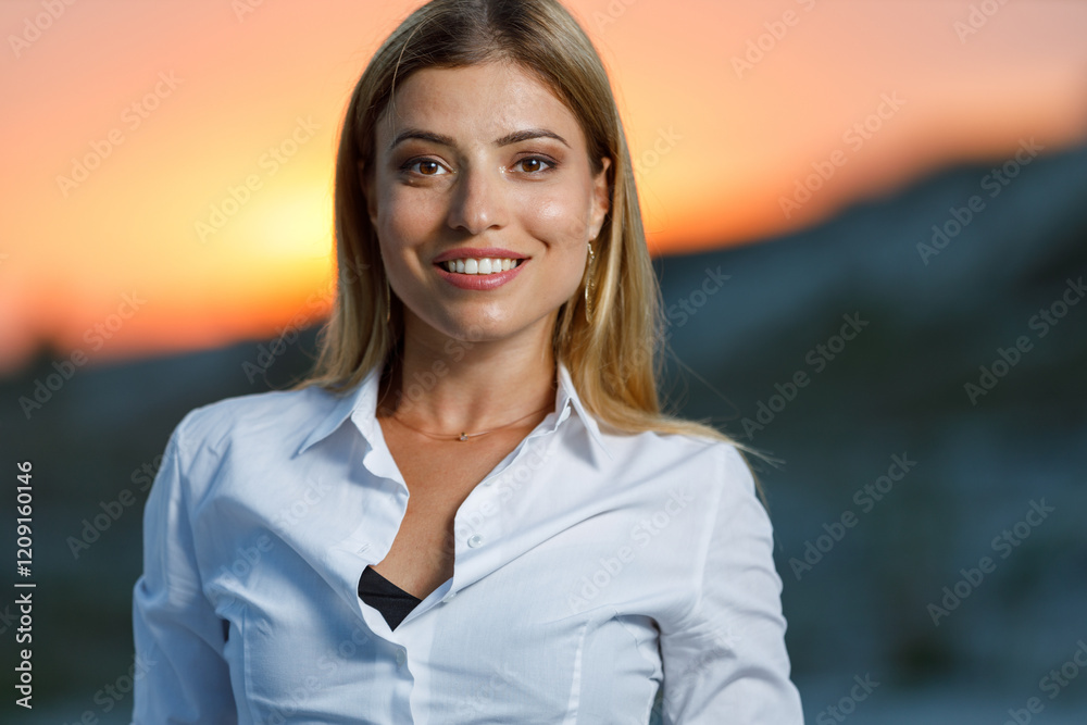 Portrait of young smiling woman standing outdoors at sunset Portrait of young smiling woman standing outdoors at sunset