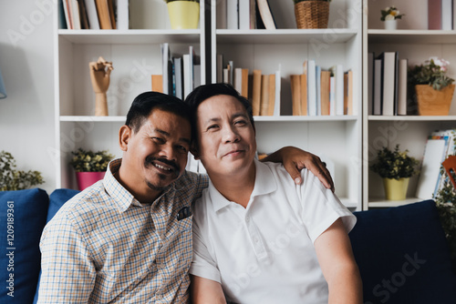Couple celebrating love and family while cherishing the journey of adoption in a cozy living room