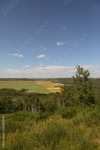 looking out at a landscape of rolling hills and farmer's fields