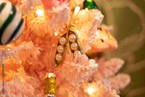 delicate pearl and gold ornaments on light pink christmas tree