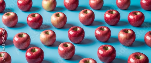 Fresh red apples arranged on a vibrant blue background symbolizing innovative agricultural practices and premium quality produce. photo