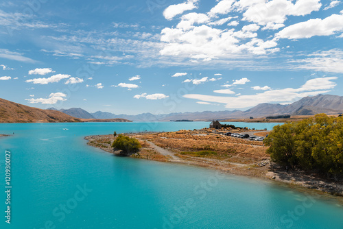 Church of the Good Shepherd at Lake Tekapo with clear blue water on a stunning summer day with blue sky (Tekapo, South Island, New Zealand)