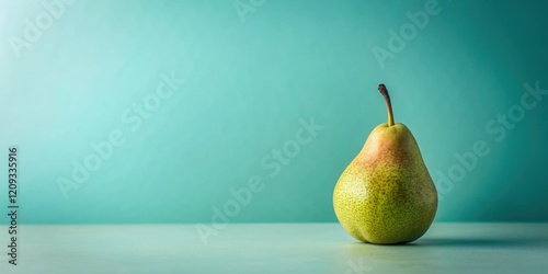 A single ripe pear rests on a tranquil teal surface against a serene teal backdrop