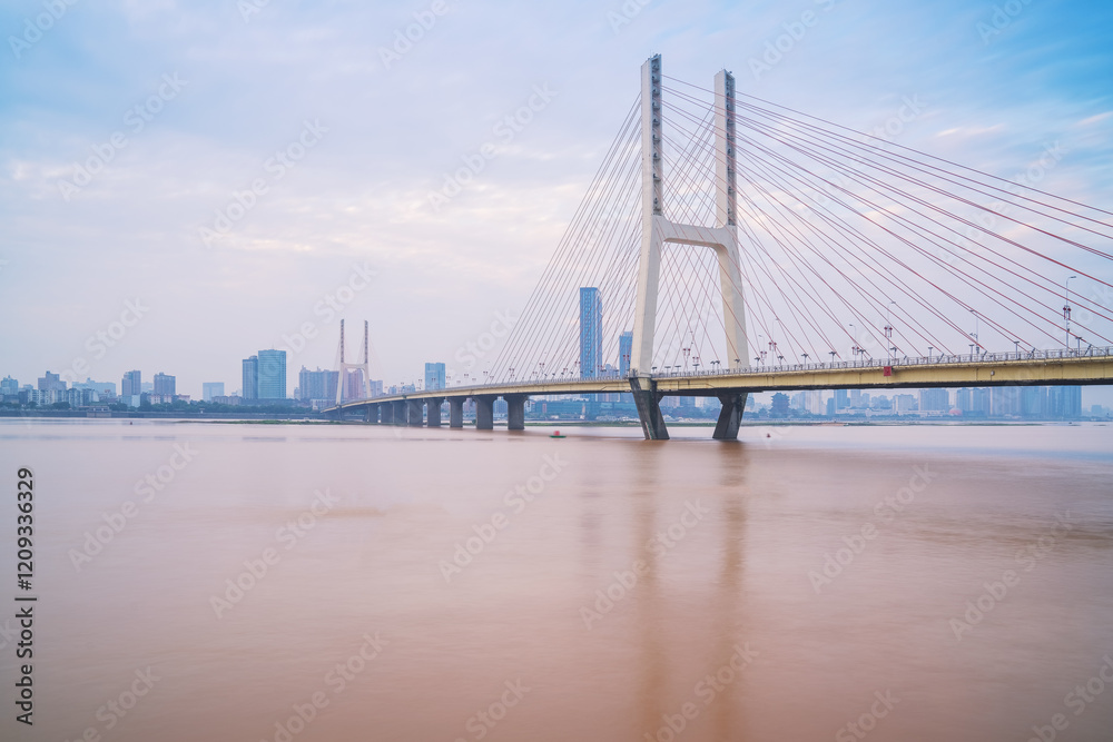 Obraz premium The urban skyline, Bayi Bridge, and Ganjiang River scenery of Nanchang City, Jiangxi Province, China on April 1, 2024