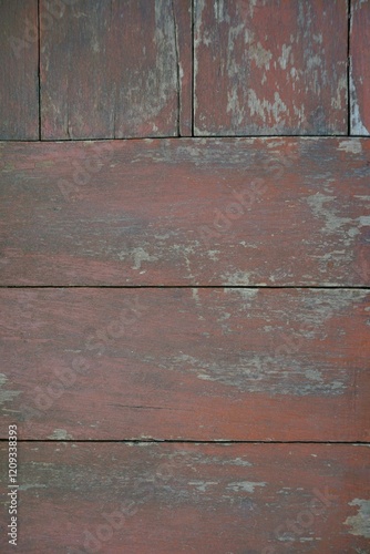 An old red wooden floor with dirt stains serves as a background.
