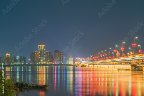 The urban skyline, hero bridge, and night view of Ganjiang River in Nanchang City, Jiangxi Province, China on April 1, 2024 photo