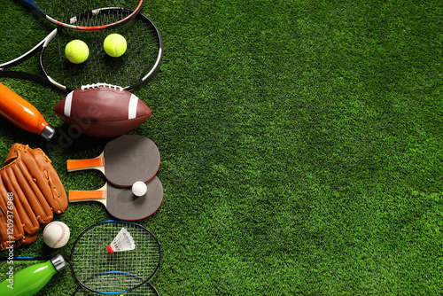 Different sports equipment on artificial grass, flat lay. Space for text photo