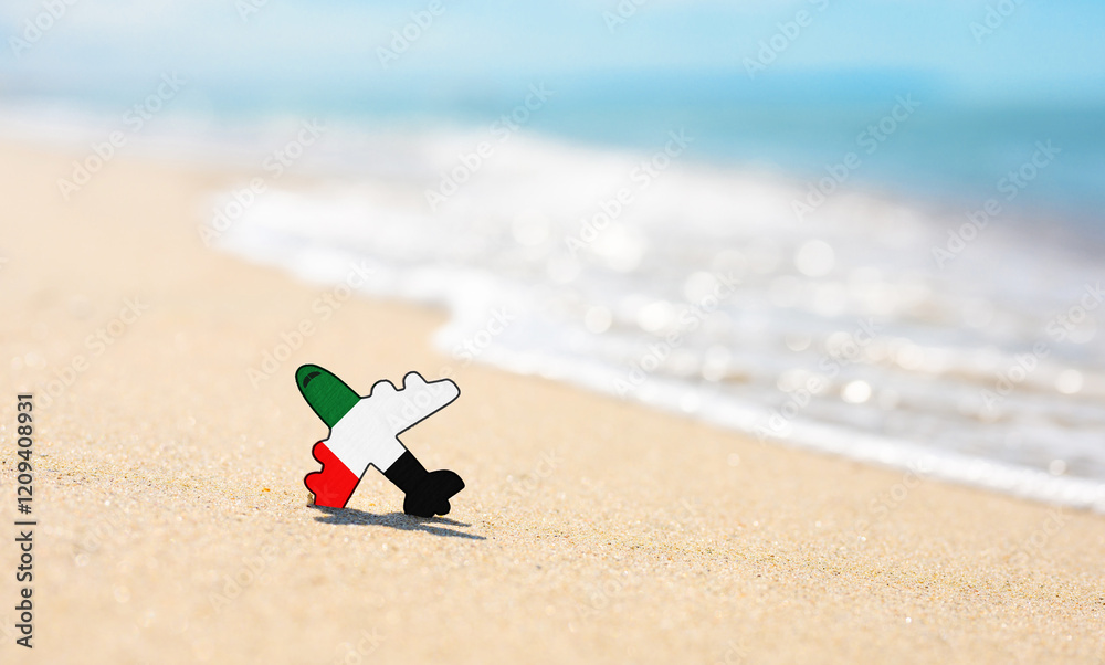 Obraz premium Vacation on the coast of the United Arab Emirates. Airplane in the colors of the flag of the United Arab Emirates on the seashore