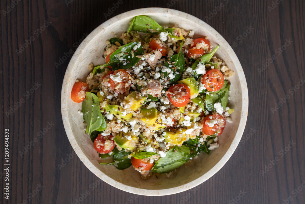 Close-up of a vibrant and nutritious salad made with quinoa, avocado, mixed seeds, and cheese, packed with protein and healthy fats for a wholesome meal Close-up of a vibrant and nutritious salad made with quinoa, avocado, mixed seeds, and cheese, packed with protein and healthy fats for a wholesome meal