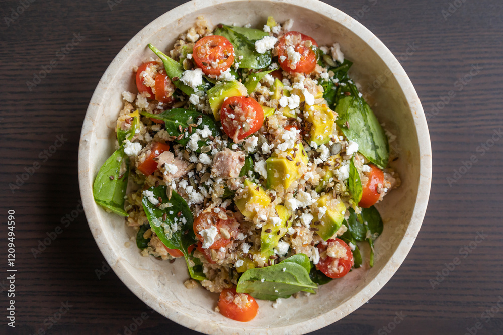 Close-up of a vibrant and nutritious salad made with quinoa, avocado, mixed seeds, and cheese, packed with protein and healthy fats for a wholesome meal Close-up of a vibrant and nutritious salad made with quinoa, avocado, mixed seeds, and cheese, packed with protein and healthy fats for a wholesome meal