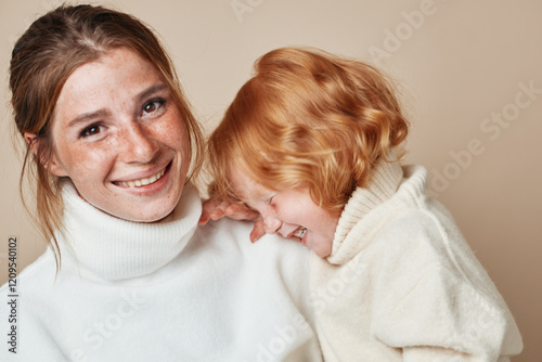 Family portrait of mother and daughter in stylish white outfits at a fashionable photoshoot event