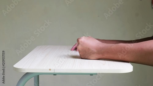 Side view of person hand punching a table showing anger emotion photo