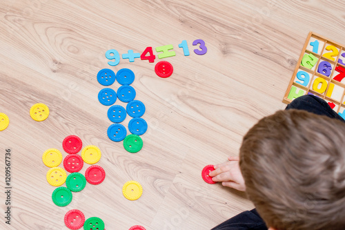Math with fun. Counting and marking large buttons with colored numbers of natural wood. DIY game. Play at home. Learning method. Early education, counting game, fine motor skills.