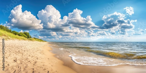 Fototapeta Naklejka Na Ścianę i Meble -  Panoramic view of the Baltic Sea with soft waves on a sandy beach under bright blue skies and fluffy white clouds, evoking summer tranquility.