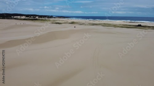 Couple Gazing at the Horizon in Sand Dunes - Aerial Drone Footage of Stockton Dunes, Australia photo