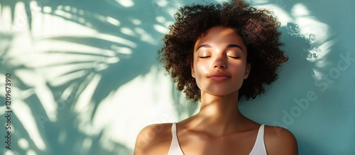 Calm woman relaxing during rejuvenating spa treatment with soft green wall and shadowed palm leaves creating a tranquil atmosphere photo