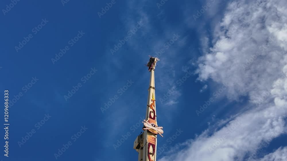 An upside down ride at the stuttgart Octoberfest wasen in Germany on a sunny late afternoon An upside down ride at the stuttgart Octoberfest wasen in Germany on a sunny late afternoon