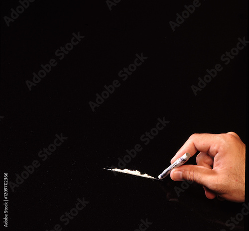 cocaine powder hand hold rolled up dollar bill