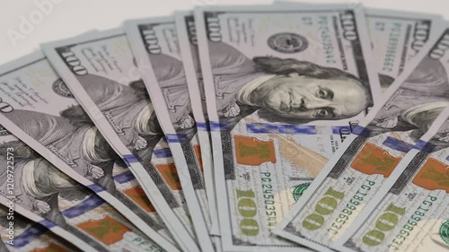 Stack of hundred dollar bills displayed neatly