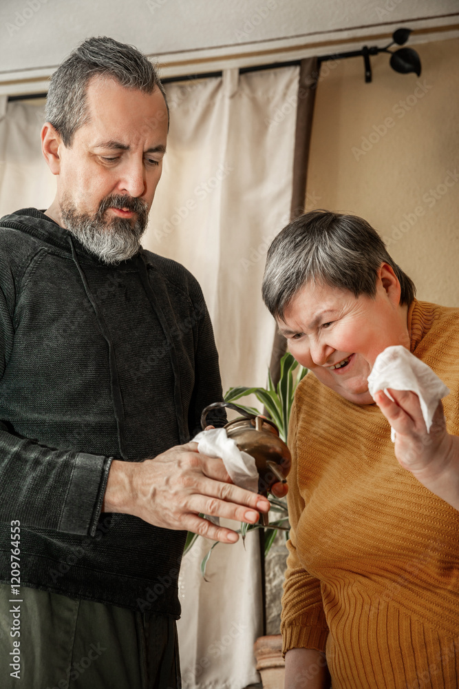 Two people, one of them with diasability, do house cleaning together Two people, one of them with diasability, do house cleaning together