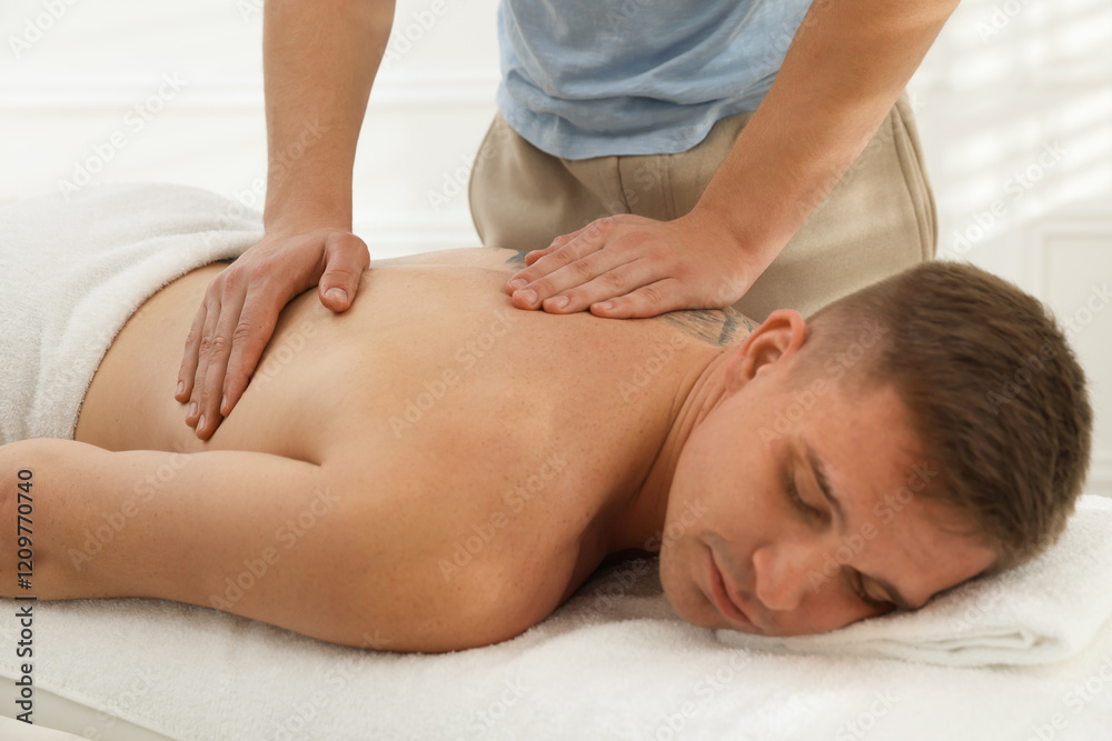 Massage therapist working with patient in clinic, closeup Massage therapist working with patient in clinic, closeup
