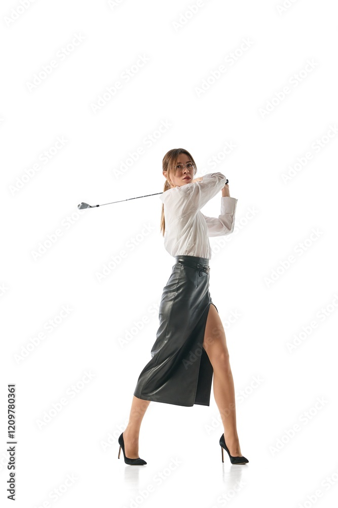 Businesswoman swinging golf club powerfully in professional attire, showcasing precision, elegance, and ambition to hit targets with strategic clarity. Concept of business, leadership, multitasking.