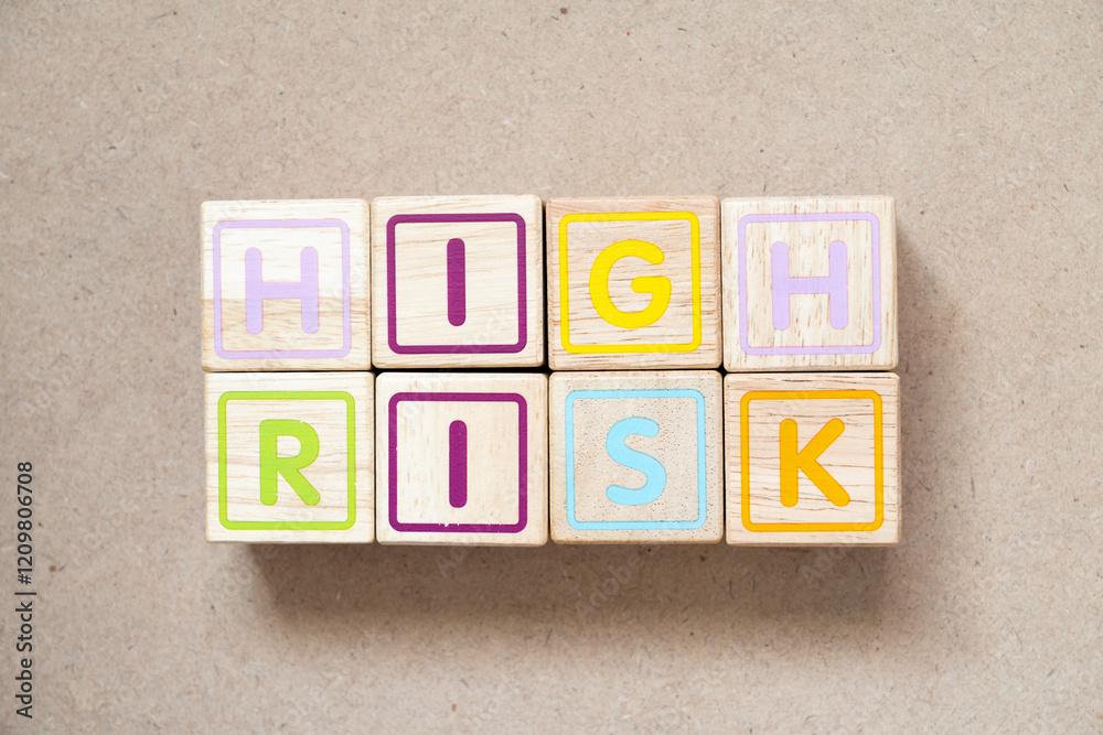 Alphabet letter block in word high risk on wood background Alphabet letter block in word high risk on wood background