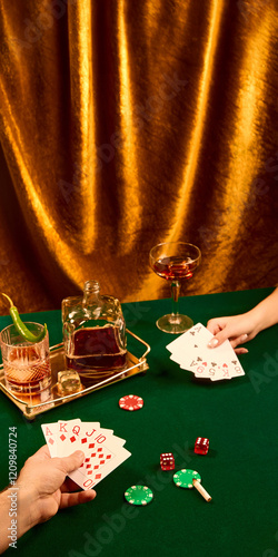 Still life photography, Man and woman playing cards, sitting at table with whiskey glasses, poker chips and dice against golden curtain. Luxury and drama. Concept of party, celebration, high-society photo