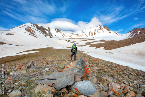Obraz na płótnie Adventurer explores snowy mountains under a vibrant sky in a remote wilderness w salonie