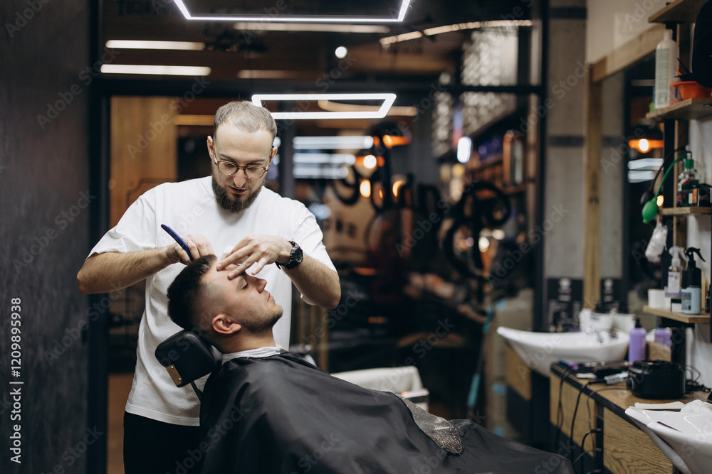 a photo of a professional barber focusing on the work of a client in a barber chair in front of a mirror in a modern barbershop a photo of a professional barber focusing on the work of a client in a barber chair in front of a mirror in a modern barbershop